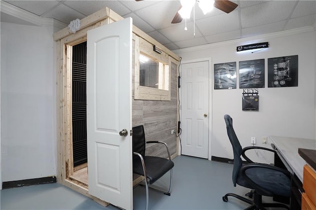 office area with concrete flooring, a paneled ceiling, and ceiling fan