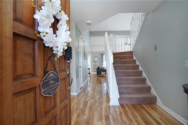 foyer featuring light hardwood / wood-style floors and a notable chandelier