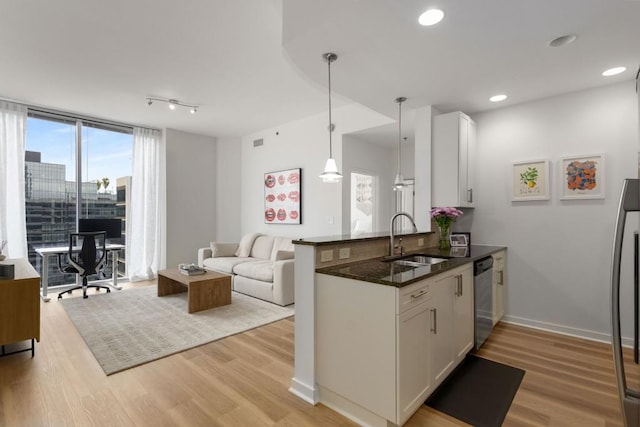 855 Peachtree St NE Unit 2706, Atlanta, GA 30308 - kitchen featuring a sink, open floor plan, stainless steel dishwasher, and light wood finished floors