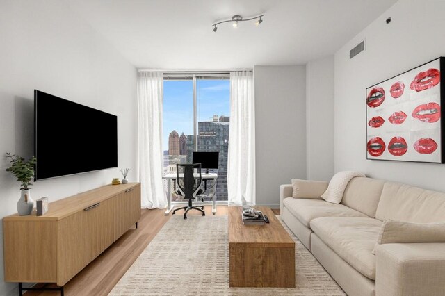 855 Peachtree St NE Unit 2706, Atlanta, GA 30308 - living area featuring light wood-type flooring, visible vents, and expansive windows