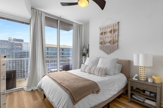 855 Peachtree St NE Unit 2706, Atlanta, GA 30308 - bedroom featuring expansive windows, multiple windows, and wood finished floors