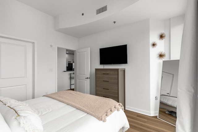855 Peachtree St NE Unit 2706, Atlanta, GA 30308 - bedroom featuring visible vents, baseboards, and wood finished floors