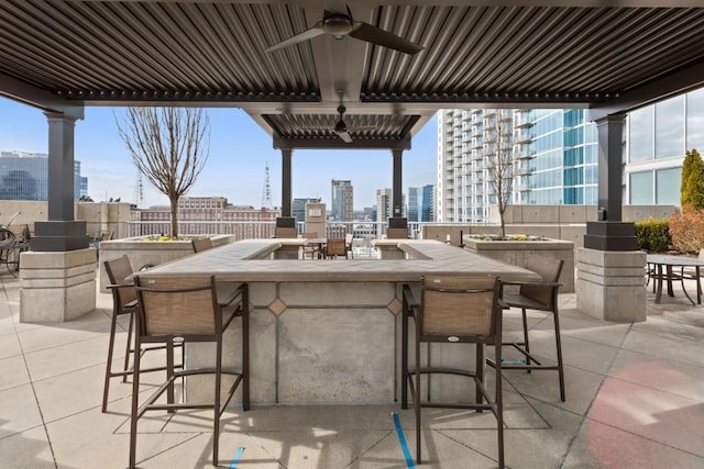 855 Peachtree St NE Unit 2706, Atlanta, GA 30308 - view of patio / terrace with a ceiling fan, a city view, outdoor dry bar, and fence