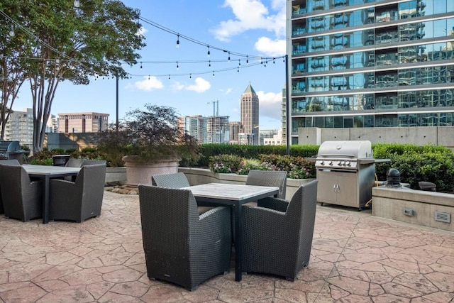 855 Peachtree St NE Unit 2706, Atlanta, GA 30308 - view of patio featuring outdoor dining space, area for grilling, and a city view
