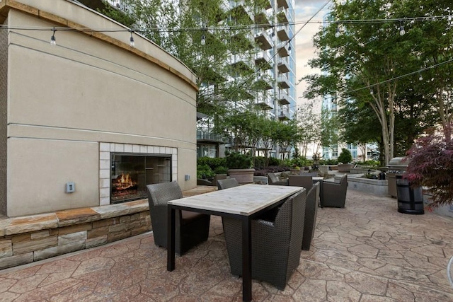 855 Peachtree St NE Unit 2706, Atlanta, GA 30308 - view of patio / terrace with outdoor dining space and a tile fireplace