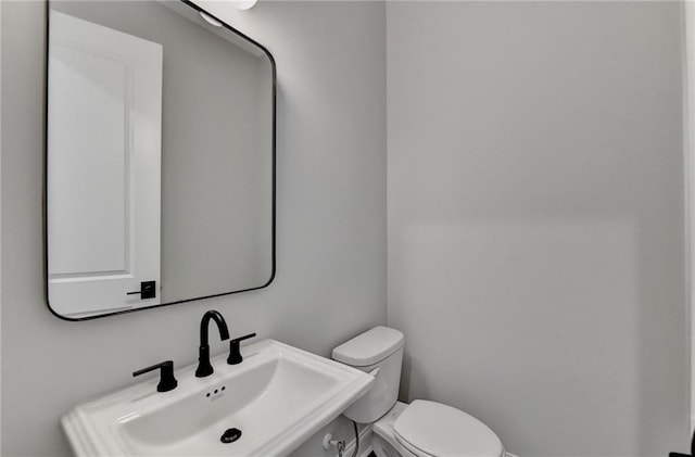 bathroom with toilet and a sink