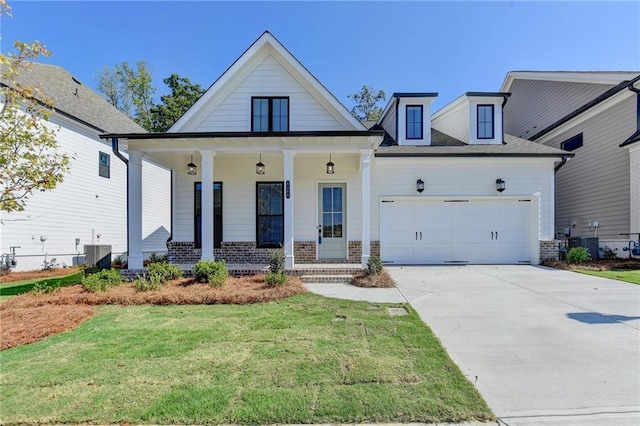 view of front of house featuring central AC, concrete driveway, covered porch, brick siding, and a garage