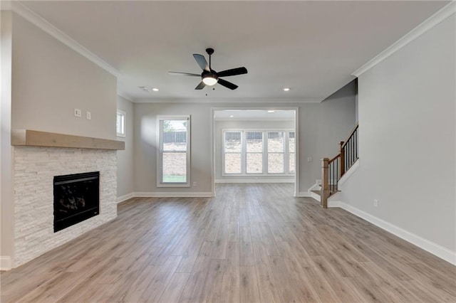 unfurnished living room with ceiling fan, baseboards, crown molding, and wood finished floors