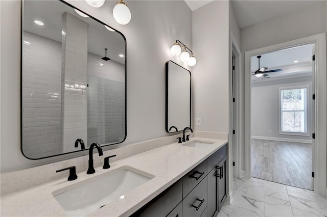 bathroom with marble finish floor, a sink, double vanity, and recessed lighting