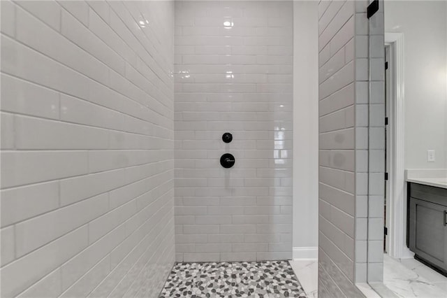 bathroom featuring vanity and tiled shower