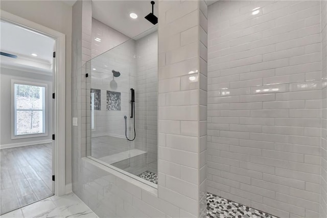 bathroom featuring baseboards, marble finish floor, and a walk in shower