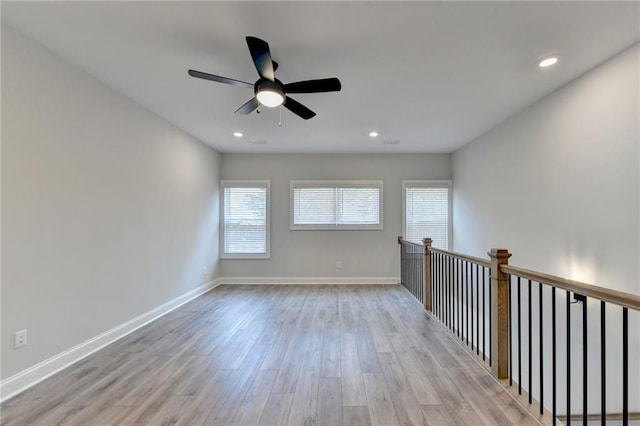 unfurnished room featuring baseboards, a ceiling fan, wood finished floors, and recessed lighting