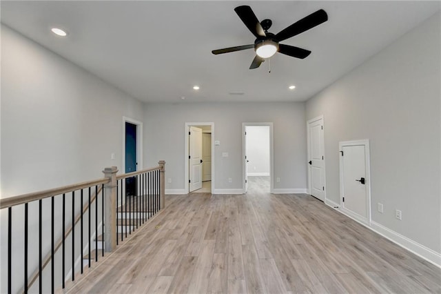 unfurnished room featuring recessed lighting, light wood-style floors, baseboards, and ceiling fan