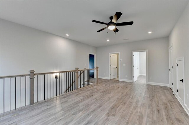 unfurnished room with baseboards, a ceiling fan, wood finished floors, and recessed lighting