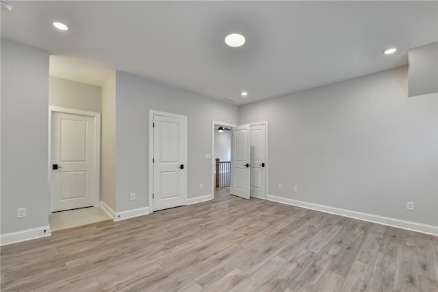 interior space featuring recessed lighting, light wood-style floors, and baseboards