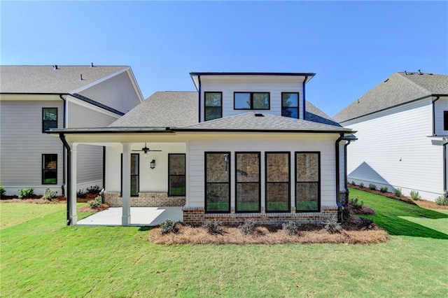 back of house with roof with shingles, brick siding, a ceiling fan, a yard, and a patio