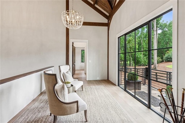 150 Trinity Farm Dr, Canton, GA 30115 - living area featuring light wood finished floors, high vaulted ceiling, and a chandelier
