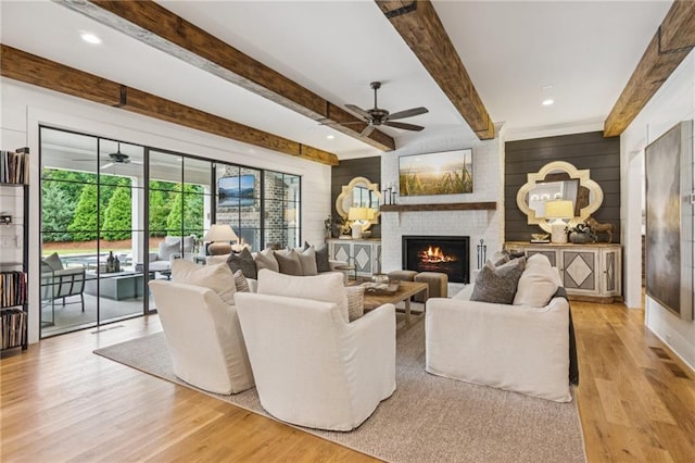 150 Trinity Farm Dr, Canton, GA 30115 - living room featuring ceiling fan, light wood-style floors, a fireplace, beamed ceiling, and wooden walls