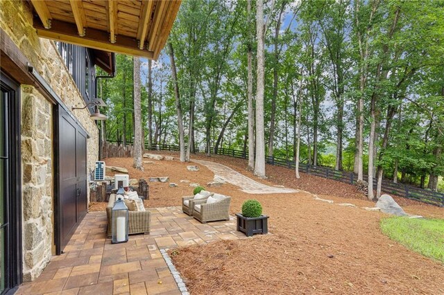150 Trinity Farm Dr, Canton, GA 30115 - fenced backyard with a patio and view of wooded area