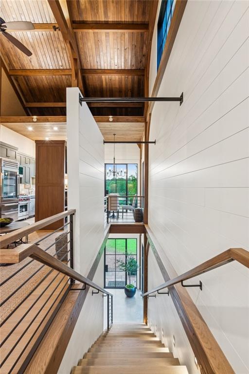 150 Trinity Farm Dr, Canton, GA 30115 - stairs with wooden ceiling, a chandelier, ceiling fan, wood finished floors, and wood walls