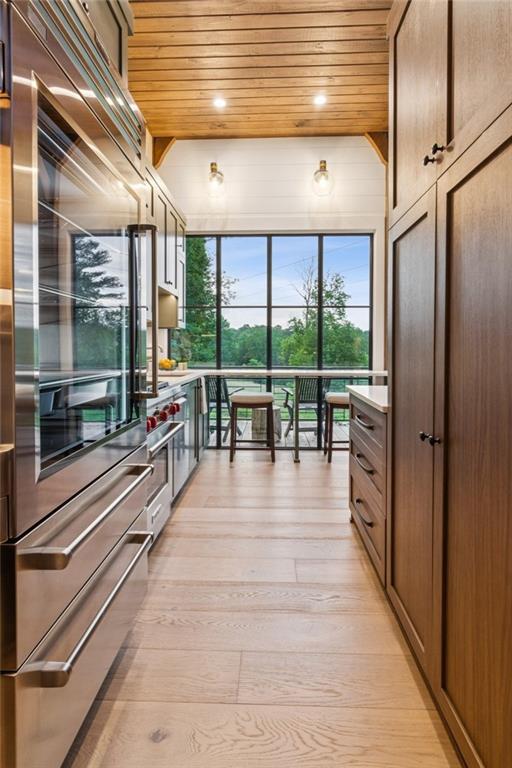 150 Trinity Farm Dr, Canton, GA 30115 - kitchen with wood ceiling, refrigerator, light wood-style flooring, and light countertops