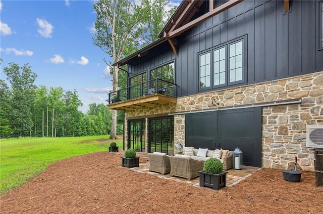150 Trinity Farm Dr, Canton, GA 30115 - rear view of house with stone siding, outdoor lounge area, a balcony, and board and batten siding