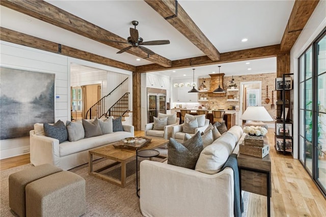 150 Trinity Farm Dr, Canton, GA 30115 - living area with light wood finished floors, beamed ceiling, stairway, and a ceiling fan