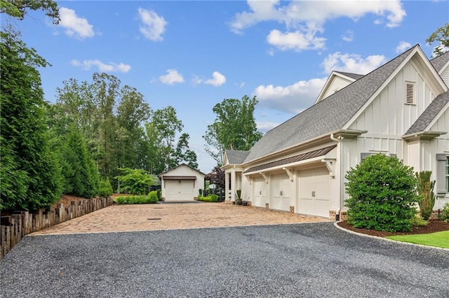 150 Trinity Farm Dr, Canton, GA 30115 - view of side of property with board and batten siding, roof with shingles, a garage, and driveway