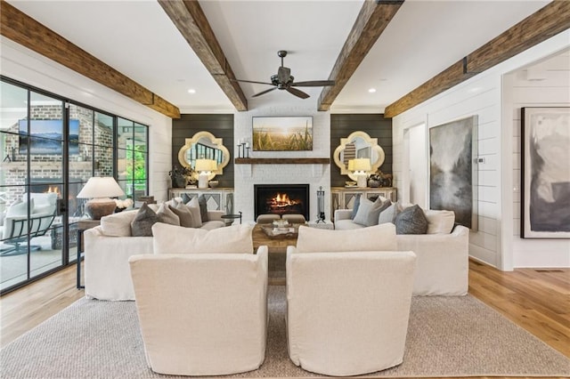 150 Trinity Farm Dr, Canton, GA 30115 - living area featuring wood finished floors, a ceiling fan, a large fireplace, beam ceiling, and wood walls