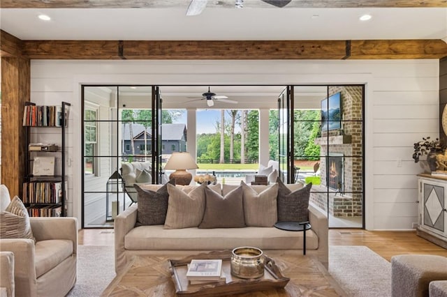 150 Trinity Farm Dr, Canton, GA 30115 - living room with a ceiling fan, beam ceiling, wood walls, and light wood-style floors