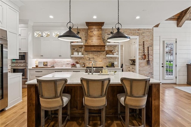 150 Trinity Farm Dr, Canton, GA 30115 - kitchen with appliances with stainless steel finishes, light countertops, decorative backsplash, light wood-type flooring, and recessed lighting