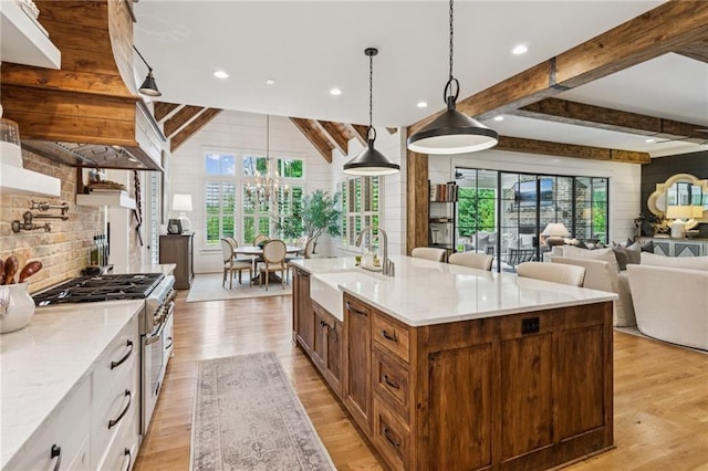 150 Trinity Farm Dr, Canton, GA 30115 - kitchen featuring double oven range, plenty of natural light, beamed ceiling, light wood finished floors, and light stone countertops