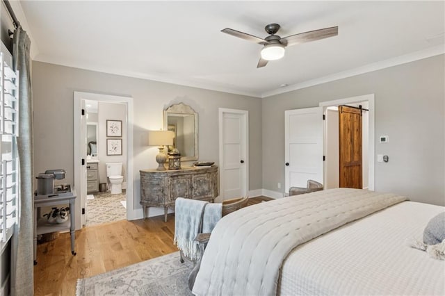150 Trinity Farm Dr, Canton, GA 30115 - bedroom featuring wood finished floors, crown molding, a barn door, ensuite bathroom, and a ceiling fan