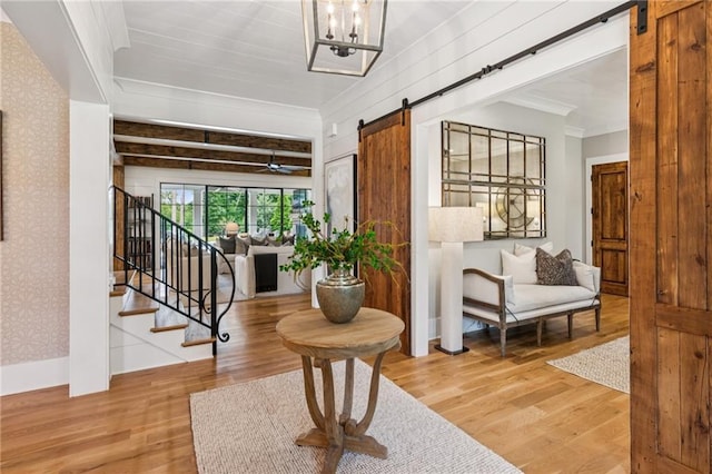150 Trinity Farm Dr, Canton, GA 30115 - entrance foyer with a barn door, wood finished floors, ornamental molding, wallpapered walls, and stairway