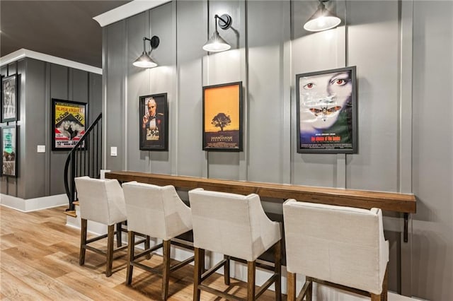 150 Trinity Farm Dr, Canton, GA 30115 - indoor dry bar featuring light wood finished floors, a decorative wall, pendant lighting, and stairs