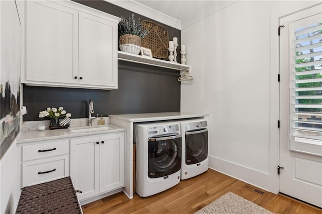 150 Trinity Farm Dr, Canton, GA 30115 - laundry room featuring cabinet space, washer and dryer, and light wood-type flooring