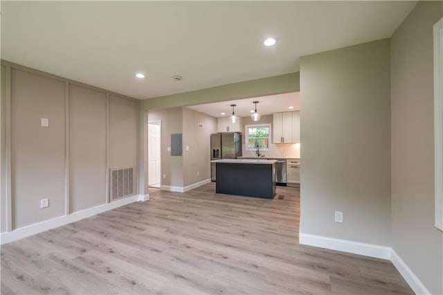 5961 John St, Austell, GA 30106 - unfurnished living room featuring light wood-type flooring, recessed lighting, and electric panel
