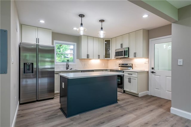 5961 John St, Austell, GA 30106 - kitchen with stainless steel appliances, decorative backsplash, a center island, light countertops, and recessed lighting