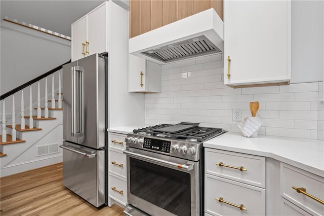 1017 Mill Creek Mnr NE, Brookhaven, GA 30319 - kitchen featuring appliances with stainless steel finishes, custom exhaust hood, light countertops, and decorative backsplash