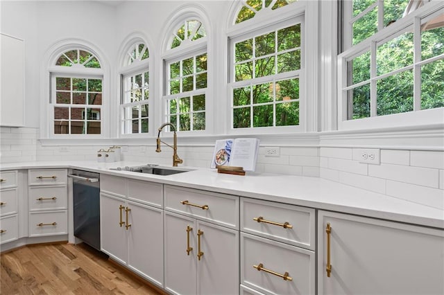 1017 Mill Creek Mnr NE, Brookhaven, GA 30319 - kitchen featuring dishwasher, decorative backsplash, and light countertops