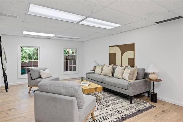 1017 Mill Creek Mnr NE, Brookhaven, GA 30319 - living room featuring a paneled ceiling and light wood-style flooring
