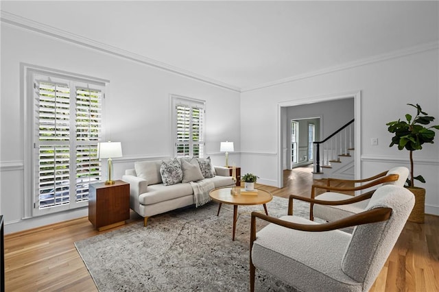 1017 Mill Creek Mnr NE, Brookhaven, GA 30319 - living area featuring crown molding, plenty of natural light, a decorative wall, light wood-style flooring, and stairway