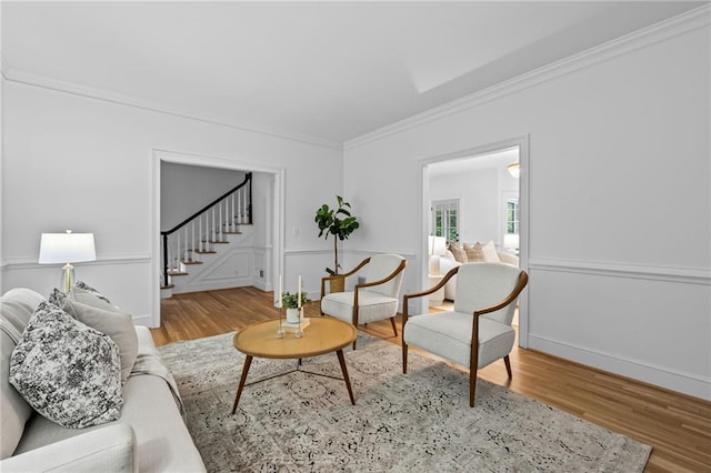 1017 Mill Creek Mnr NE, Brookhaven, GA 30319 - living room featuring stairs, wood finished floors, and crown molding