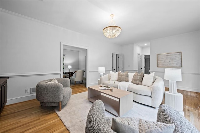 1017 Mill Creek Mnr NE, Brookhaven, GA 30319 - living area with a chandelier, wood finished floors, and crown molding