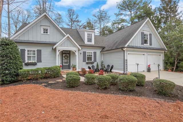 view of front facade featuring concrete driveway, metal roof, roof with shingles, a standing seam roof, and board and batten siding