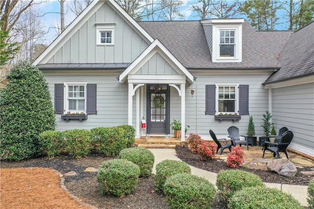 view of front of home featuring board and batten siding and a shingled roof