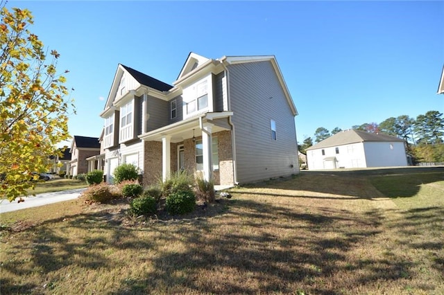 view of home's exterior featuring a garage, a lawn, and brick siding