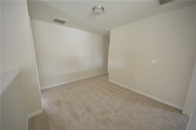 carpeted empty room with baseboards and visible vents