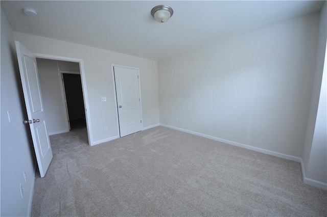 unfurnished bedroom featuring baseboards and carpet floors