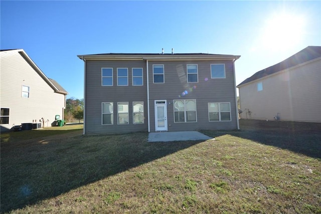 rear view of property featuring a lawn and a patio area